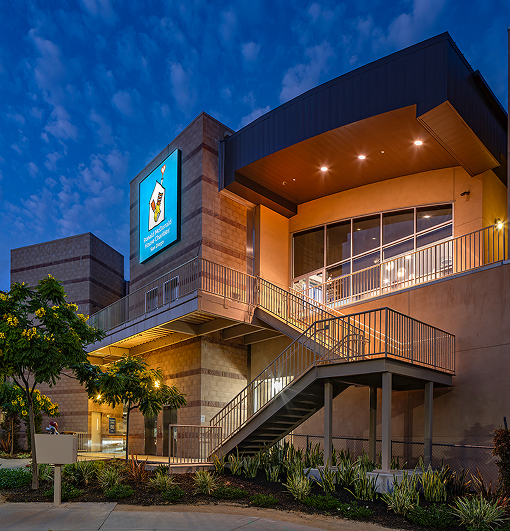 Side angle view of the Ronald McDonald House and big blue sign