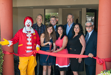 Ribbon cutting with Ronald and group of people
