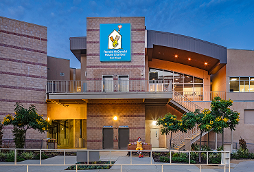Front view of the Ronald McDonald House with bright blue sign