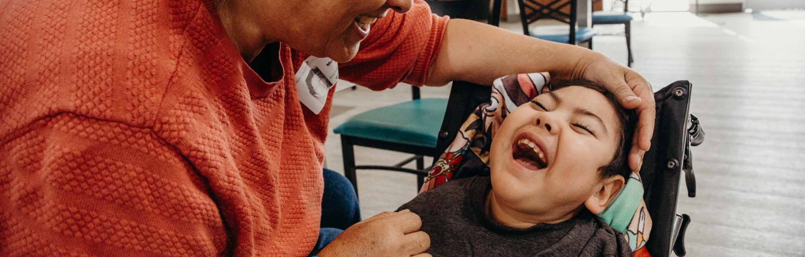Son laughing while looking at his mom