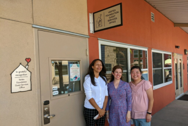 Vertex Foundation members standing in front of the Vertex Guest Services Office