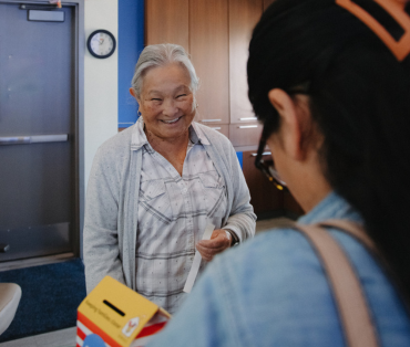 front desk volunteer smiling