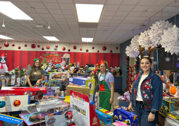 room filled with toys and people in holiday clothing