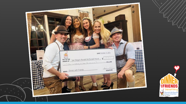 Dinner with Friends Committee holding large check